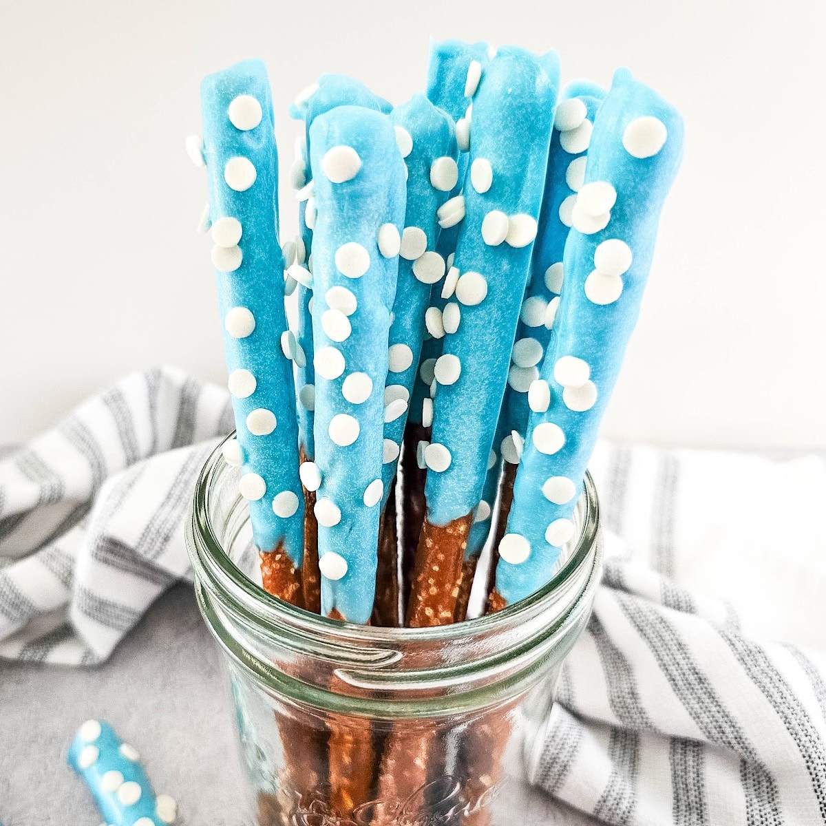 blue candy coated pretzel rods featured image