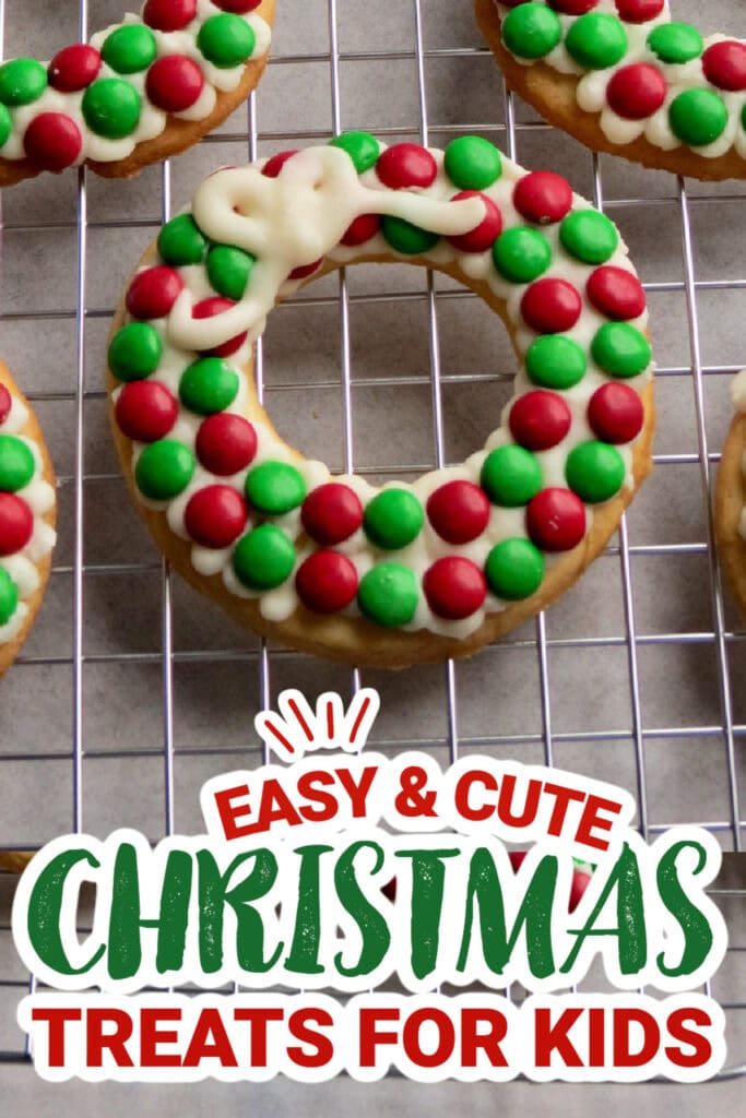 Festive Christmas cookies decorated with red and green candies on a cooling rack.